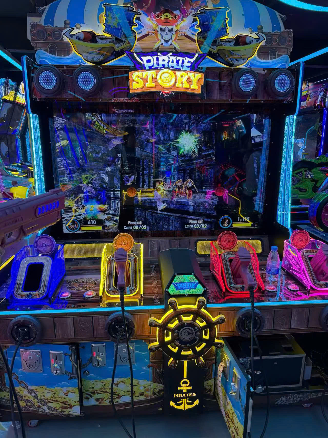 Chủ đề hải tặc với màn hình lớn hiển thị cảnh biển và tàu, đèn LED viền sáng, 2 súng hồng và vàng đặt trên bàn điều khiển Chủ đề hải tặc với màn hình lớn hiển thị cảnh biển và tàu, đèn LED viền sáng, 2 súng hồng và vàng đặt trên bàn điều khiển